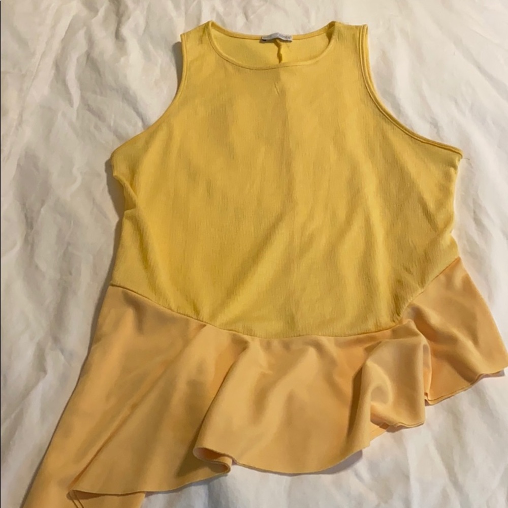 Yellow tank with Asymmetrical ruffle bottom.